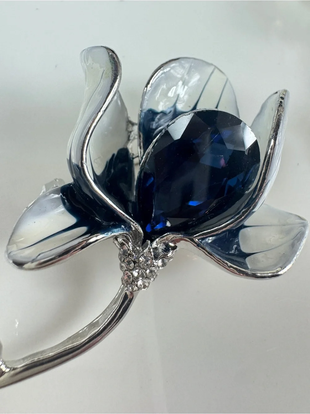 Silver Floral Brooch with Deep Blue Faceted Crystal